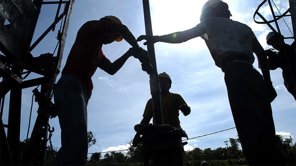 Three Men using drilling Equipment