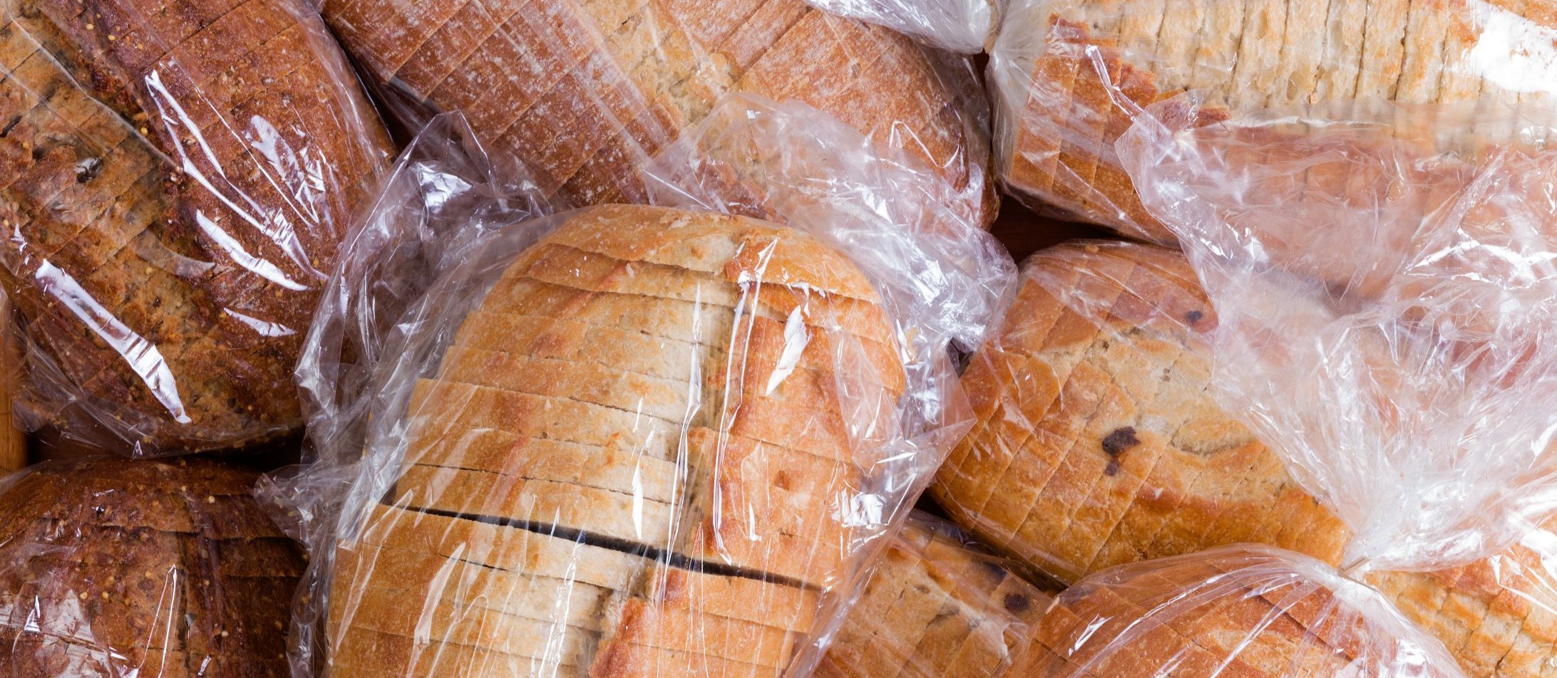 Plastic film covered bread