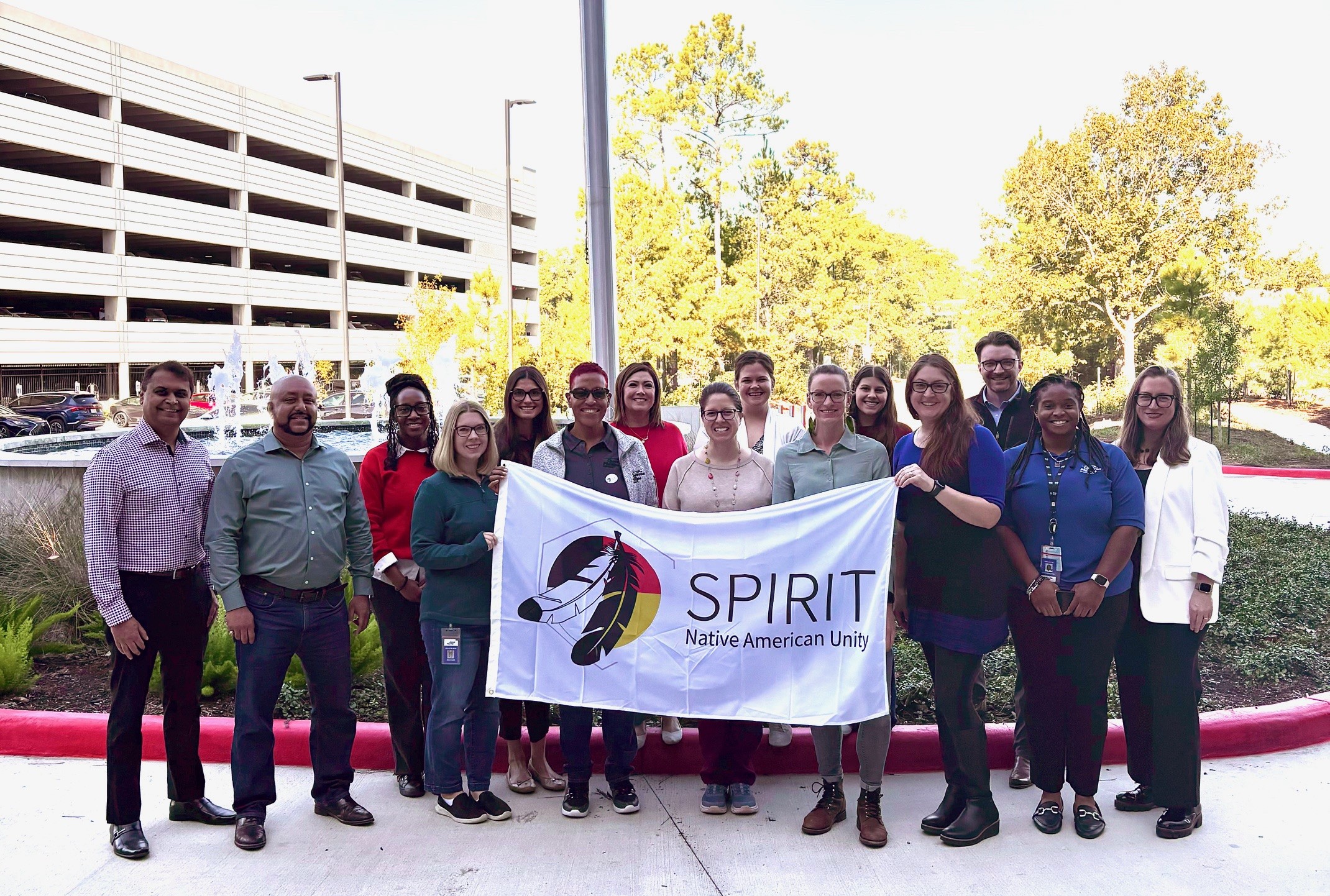 Employees holding SPIRIT flag